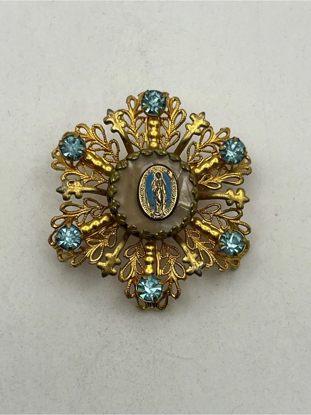 Miraculous medal Catholic Virgin Mary blue rhinestone gold tone starburst brooch